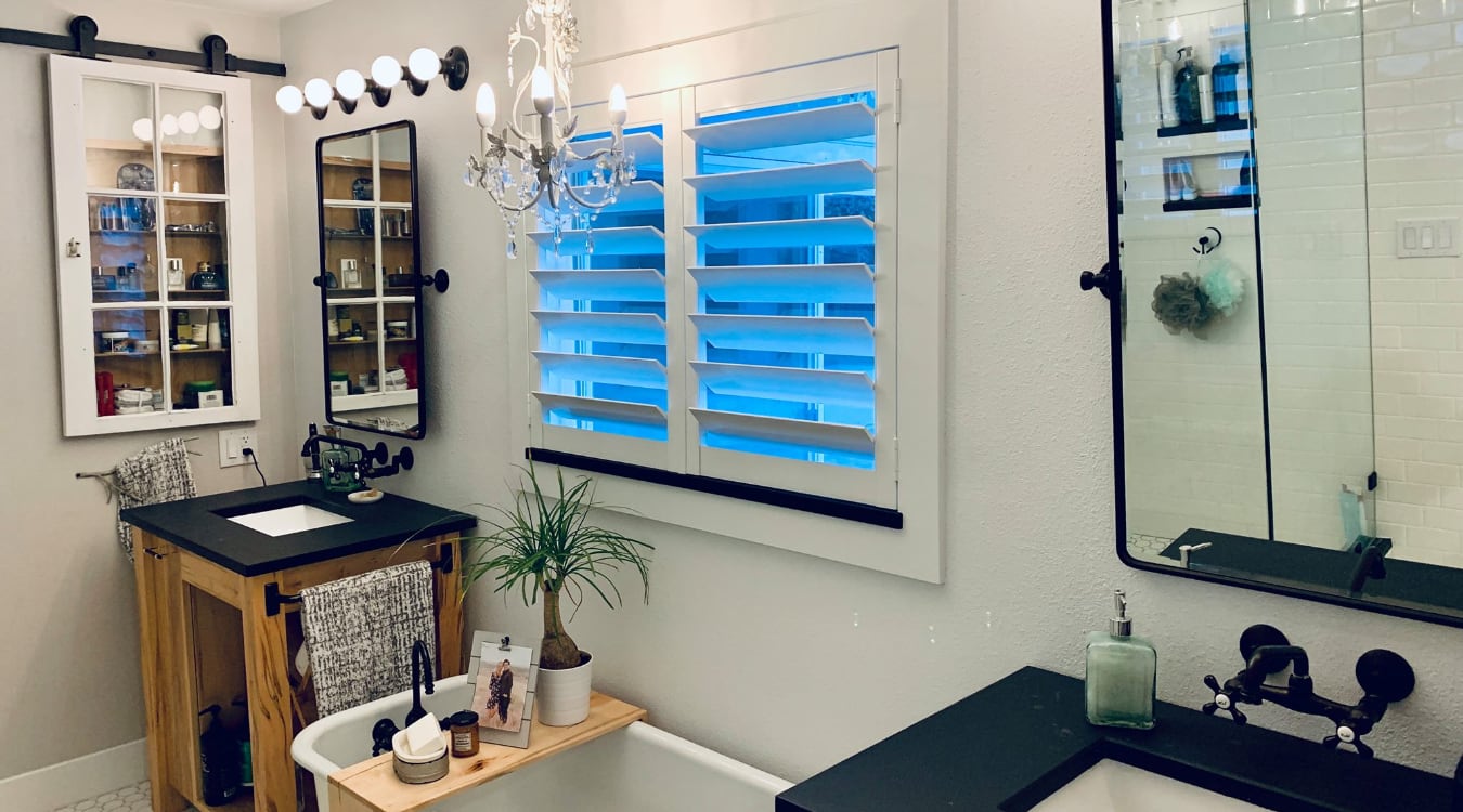 Plantation shutters in a white bathroom